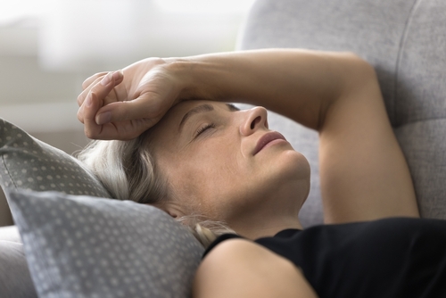 Woman with menopause symptoms tired woman with brain fog and excess heat